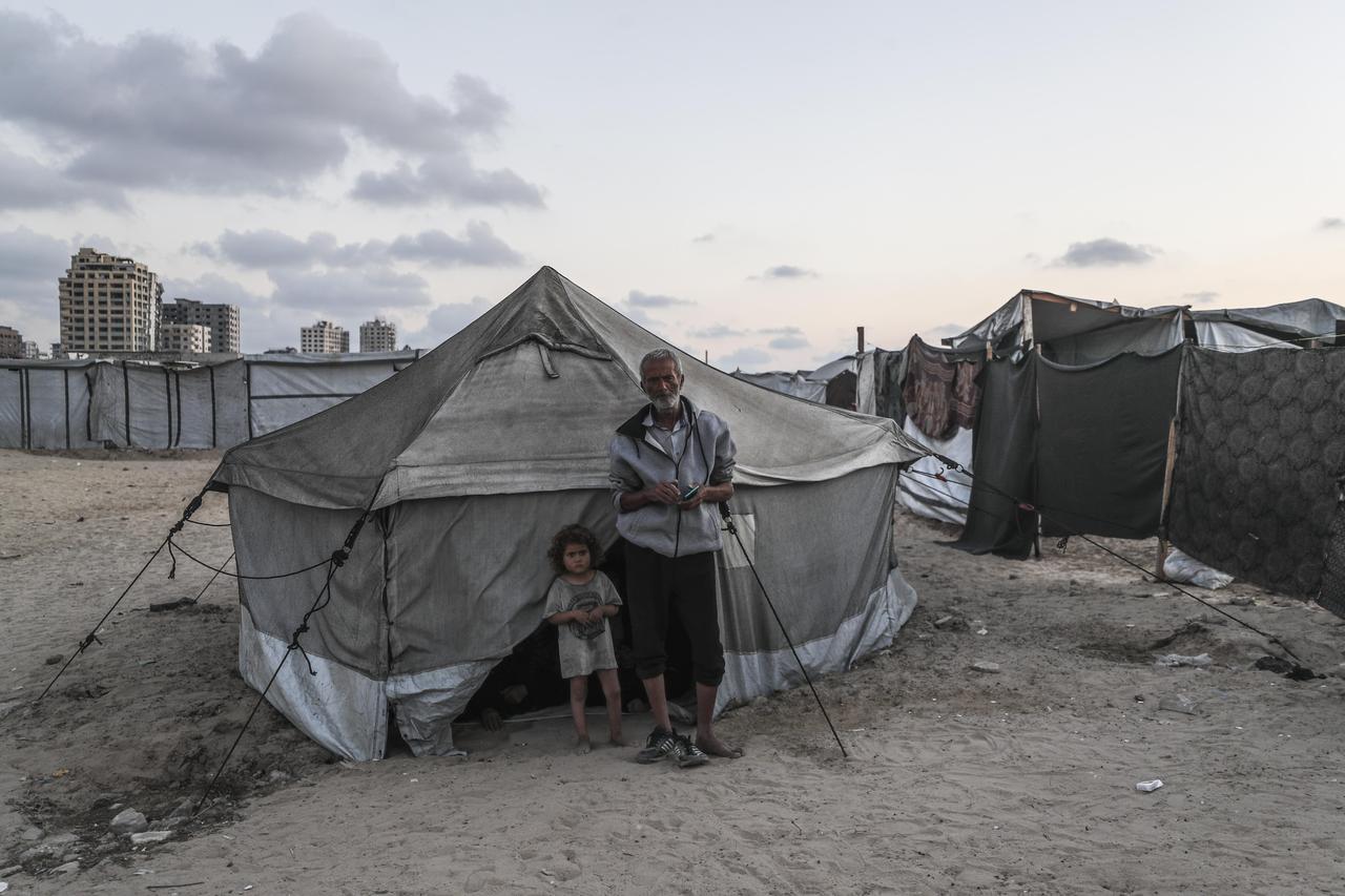 Displaced Palestinian women and a child sit in front of their makeshift tent at a camp in Gaza City, as Palestinians continue to live in dire conditions after being forced from their homes by ongoing Israeli attacks on Gaza on June 05, 2025. (AA Photo)