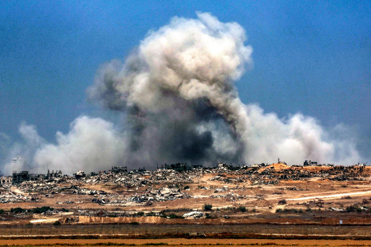 A plume of smoke erupts during Israeli bombardment in the Gaza Strip as pictured from across the border in southern Israel on June 5, 2025, amid the ongoing war between Israel and Hamas. Gazas civil defence agency said Israeli strikes killed at least 10 people in the battered Palestinian territory on June 5 as the military keeps up an intensified offensive. (Photo by Jack GUEZ / AFP)