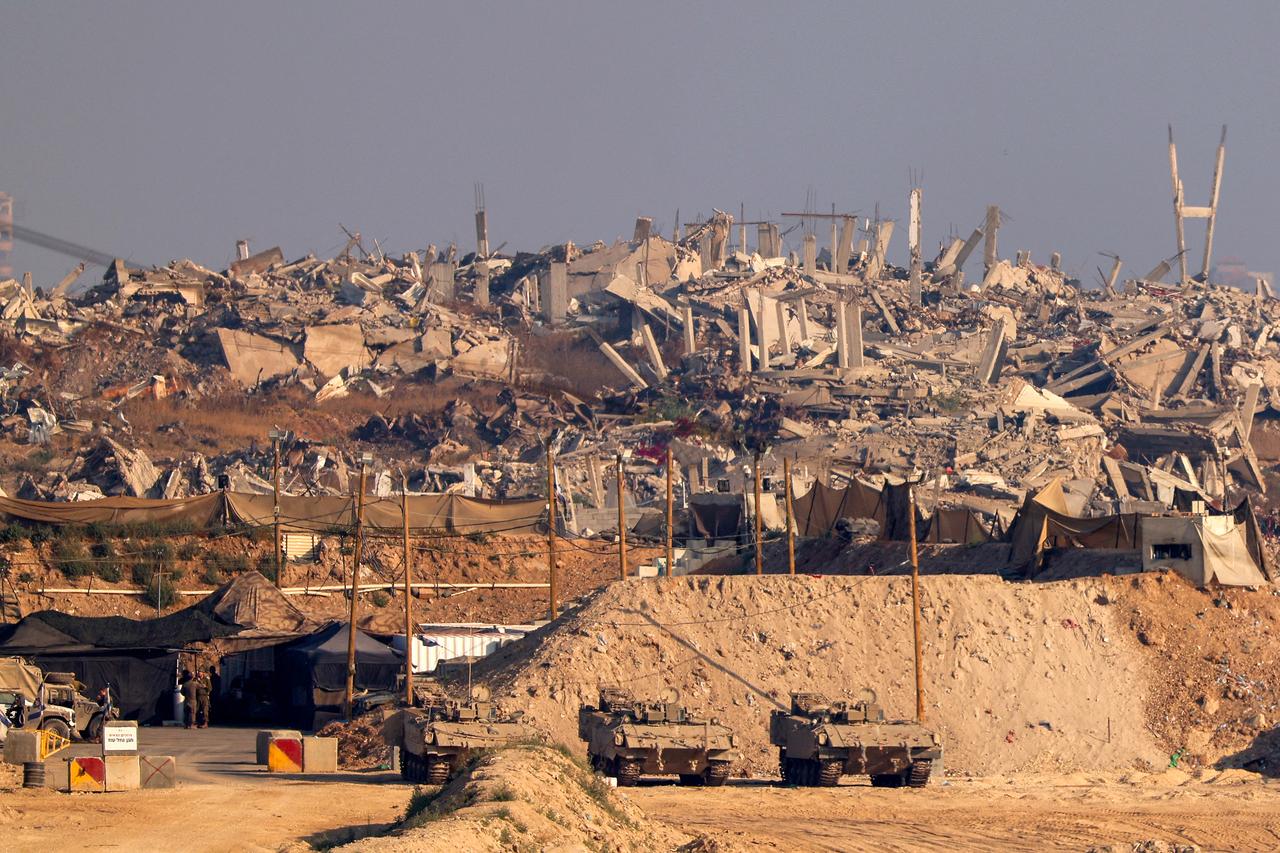 In this picture, taken from the Israeli border with the Gaza Strip, Israeli soldiers stay at a position near destroyed buildings in the besieged Palestinian territory on June 5, 2025. Gazas civil defence agency said Israeli strikes killed at least 10 people in the battered Palestinian territory on June 5 as the military keeps up an intensified offensive. (Photo by Jack GUEZ / AFP)