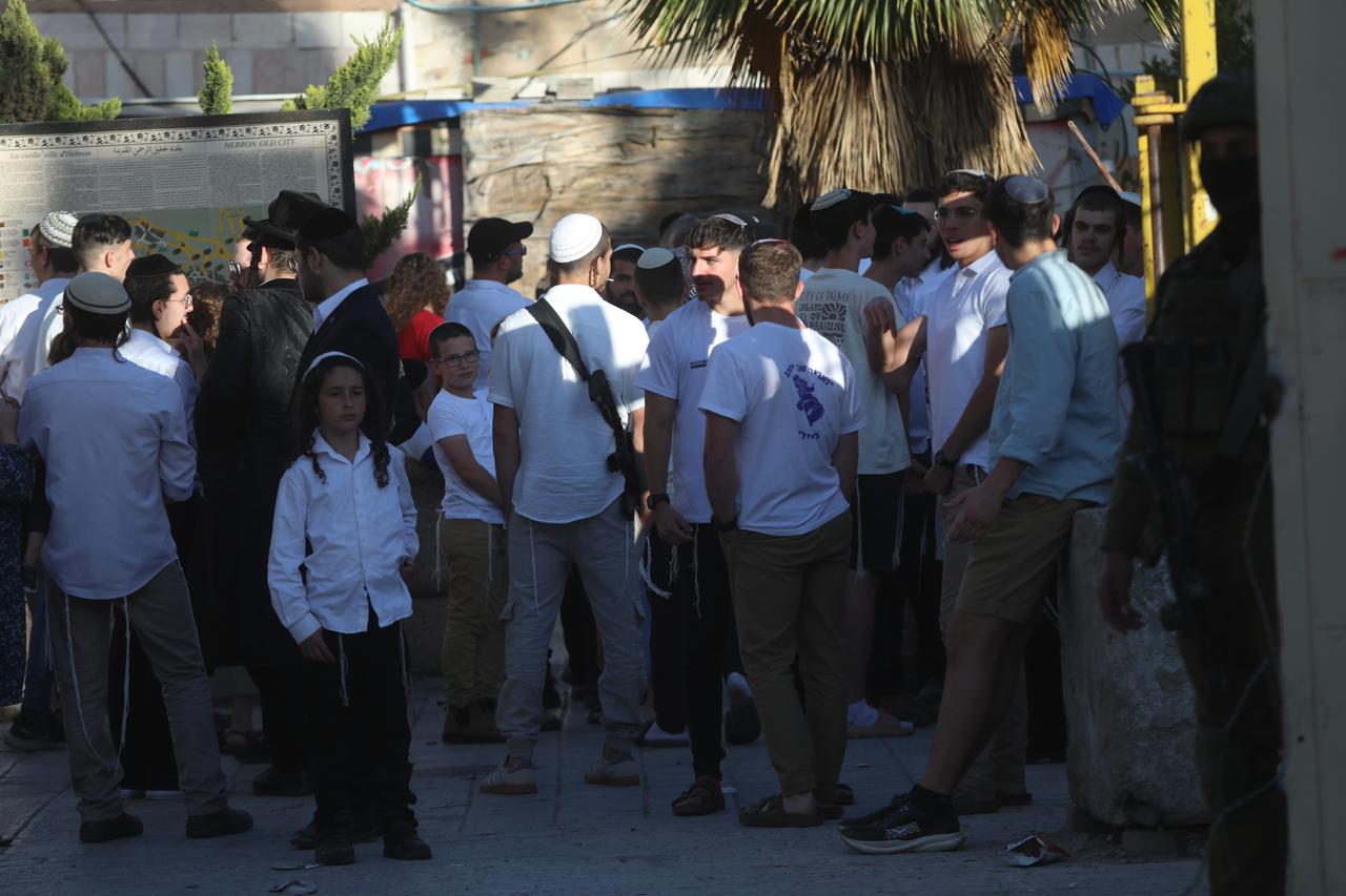 Israeli settlers organize a provocative tour at the city under the protection of Israeli forces in Hebron, West Bank on May 22, 2025. (AA Photo)