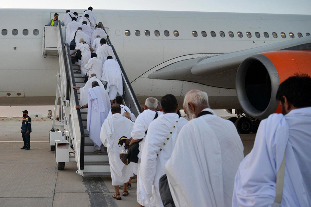 Afghan Hajj pilgrims board a plane to Saudi Arabia at Kandahar airport on May 12, 2025. (AFP Photo)