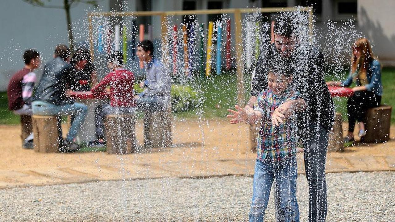 A child with autism plays under water spray with a caregiver at Türkiye’s largest Sensory Park in Gebze, Kocaeli, on June 3, 2017. (AA Photo)