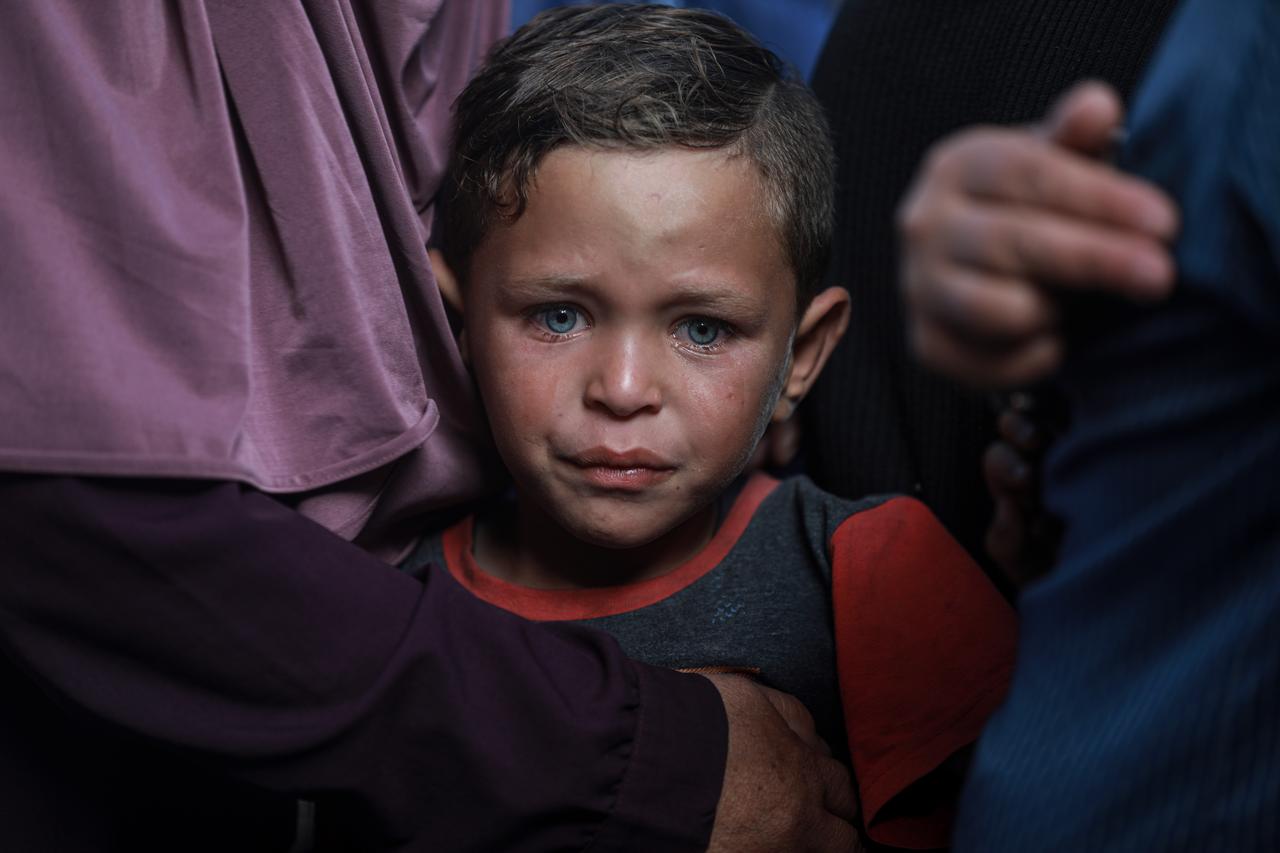 A Palestinian child sheds tears while mourning during the funeral ceremony for Palestinians killed as Israeli forces carried out airstrikes on a vehicle in the Al-Atatra area of Beit Lahia, Gaza, on the first day of Eid al-Adha, June 6, 2025. (AA Photo)