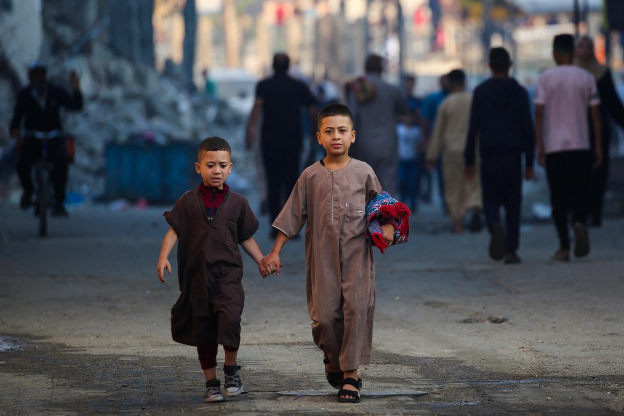 Two children leave after participating in a special morning prayer on the first day of the Muslim Eid al-Adha festival in Nuseirat, central Gaza Strip, on June 6, 2025. (AFP Photo)