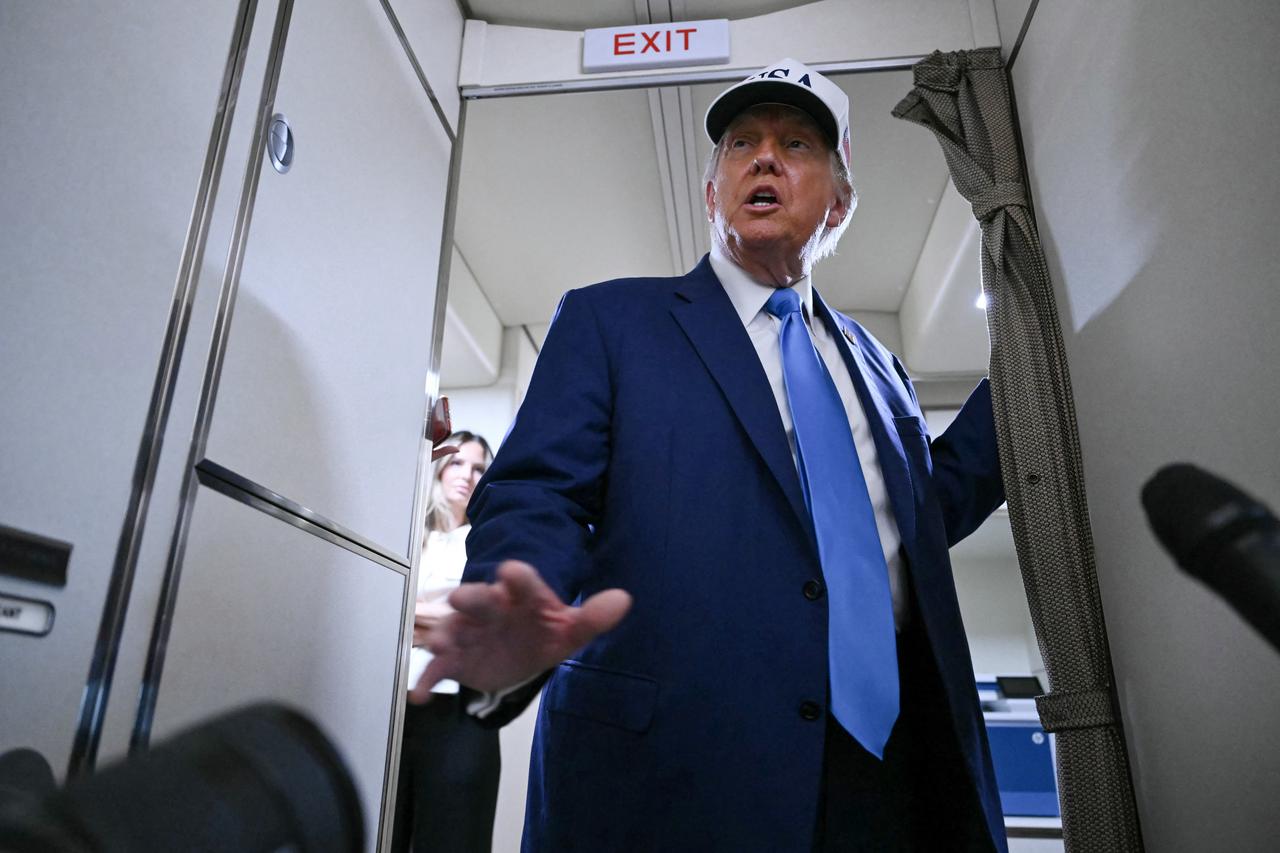 US President Donald Trump talks to the press aboard Air Force One on the way to Morristown Municipal Airport in Morristown, New Jersey, on June 6, 2025. Trump is travelling to his residence and golf club in Bedminster, New Jersey. (Photo by ANDREW CABALLERO-REYNOLDS / AFP)
