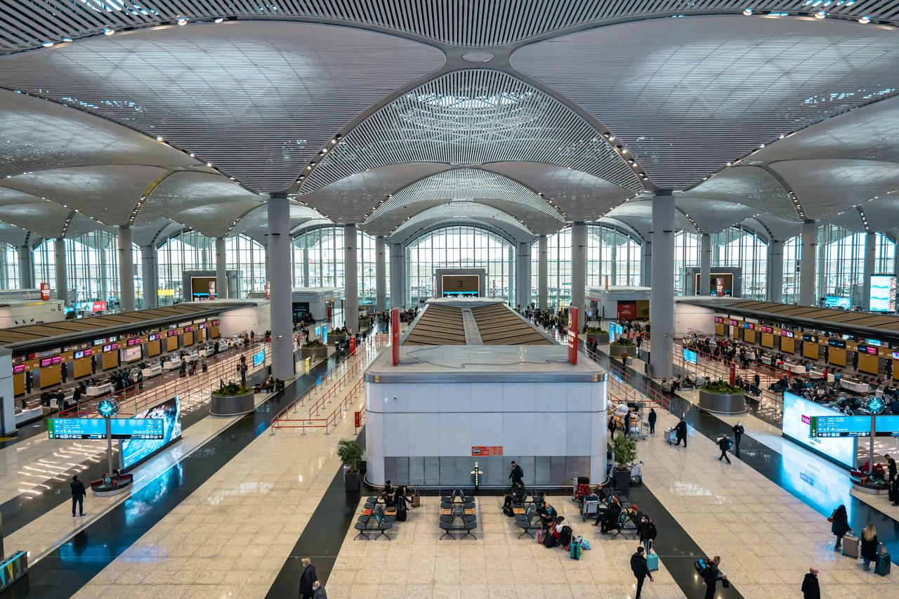 Travelers walk through the spacious departure hall of Istanbul Airport in Türkiye, on November 6, 2021. (Adobe Stock Photo)