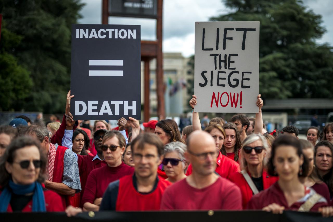 Staffs of Doctors Without Borders (Medecins Sans Frontieres) (MSF) march carrying placards as they stage a demonstration against the militarisation of supplies of humanitarian aid in the Gaza strip, next to the United Nations Offices in Geneva on June 5, 2025. (Photo by Fabrice COFFRINI / AFP)