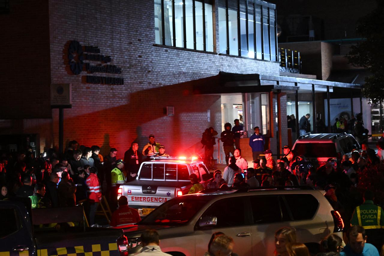 People wait outside the Clinic Fundación Santa Fe, where Senator Miguel Uribe is receiving medical treatment after being shot and wounded in Bogota on June 7, 2025. (AFP Photo)