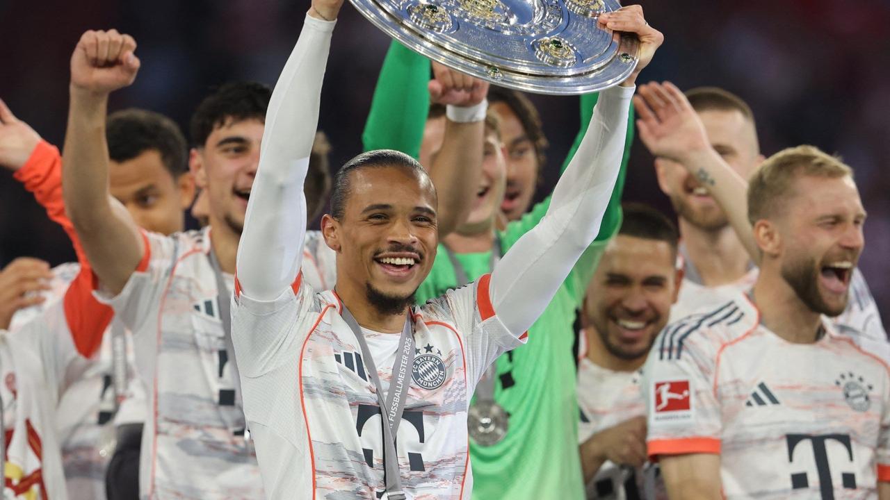Bayern Munichs German forward #10 Leroy Sane lifts the trophy after the German first division Bundesliga football match between Bayern Munich and Borussia Moenchengladbach in Munich on May 10, 2025. (AFP Photo)