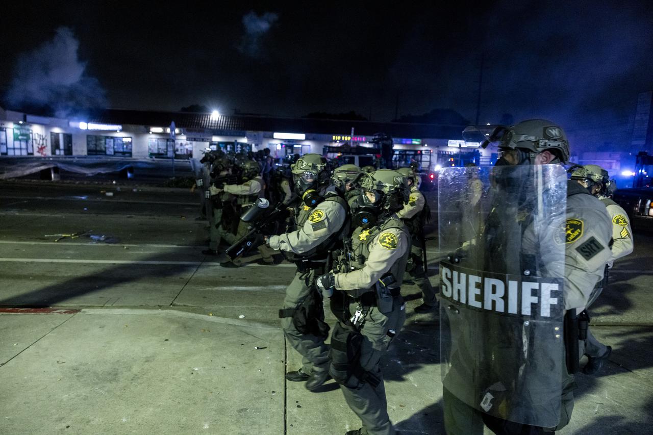Law enforcement clash with demonstrators during a protest following federal immigration operations, in the Compton neighborhood of Los Angeles, California early on June 8, 2025. (AFP Photo)