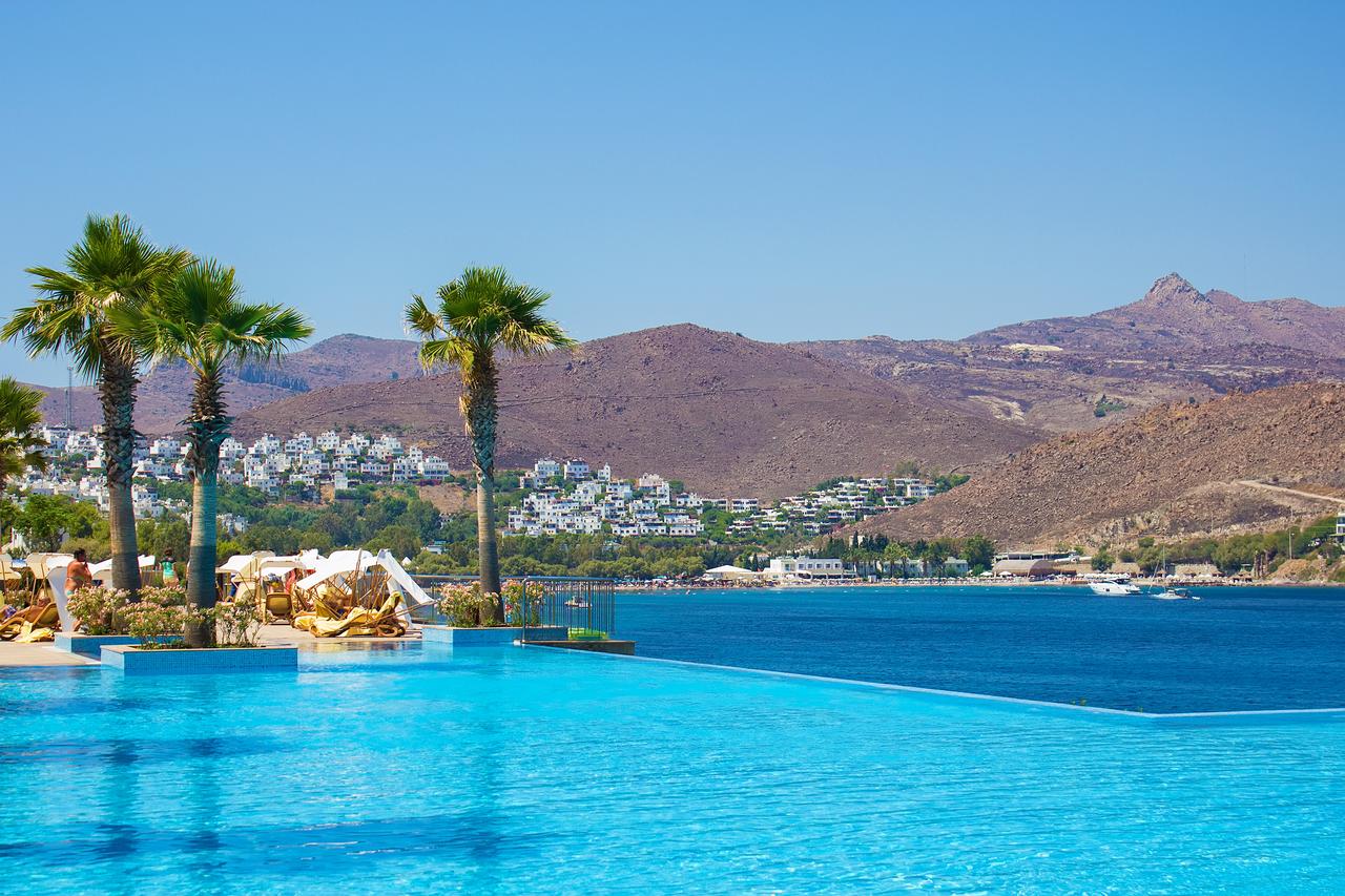 A panoramic view of a luxury hotel pool overlooking the turquoise Aegean Sea in Bodrum, Mugla, Türkiye, accessed on June 8, 2025. (Adobe Stock Photo)