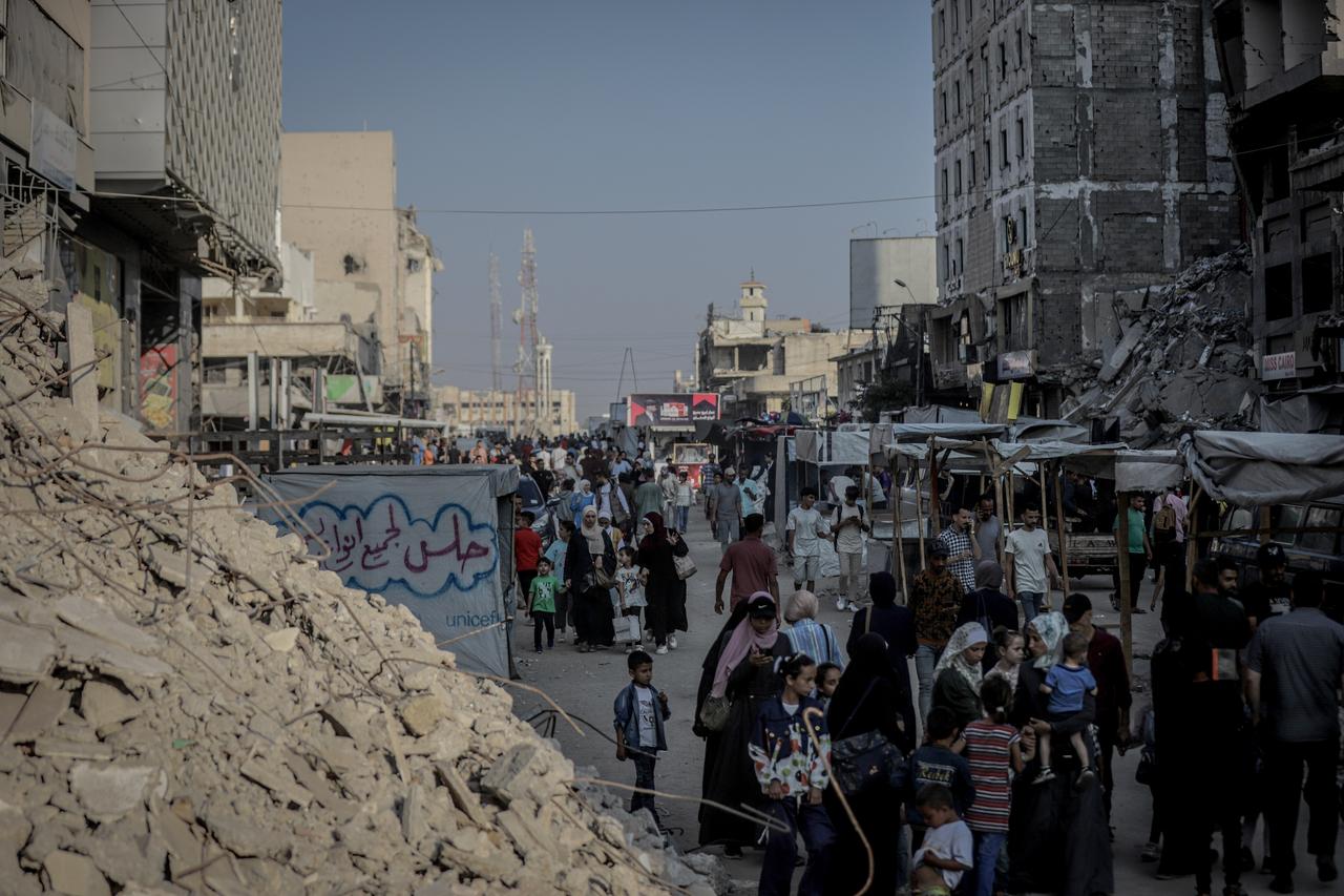 Displaced Palestinians gather among makeshift tents and small market stalls set up amid rubble in the al-Rimal neighborhood of central Gaza on the second day of Eid al-Adha, as they try to observe the holiday despite difficult living conditions in Gaza on June 07, 2025. (AA Photo)