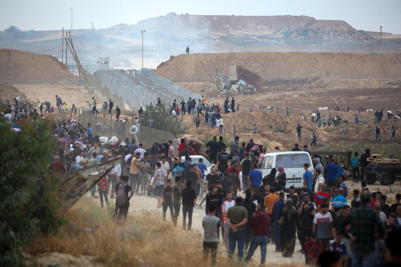 A member of a private US security company, contracted by the Gaza Humanitarian Foundation (GHF), a private US-backed aid group that has bypassed the longstanding UN-led system in the territory, looks on from a hill on the so called Netzarim corridor in the central Gaza Strip as displaced Palestinians gather to receive relief supplies at a distribution centre on June 8, 2025. (AA Photo)