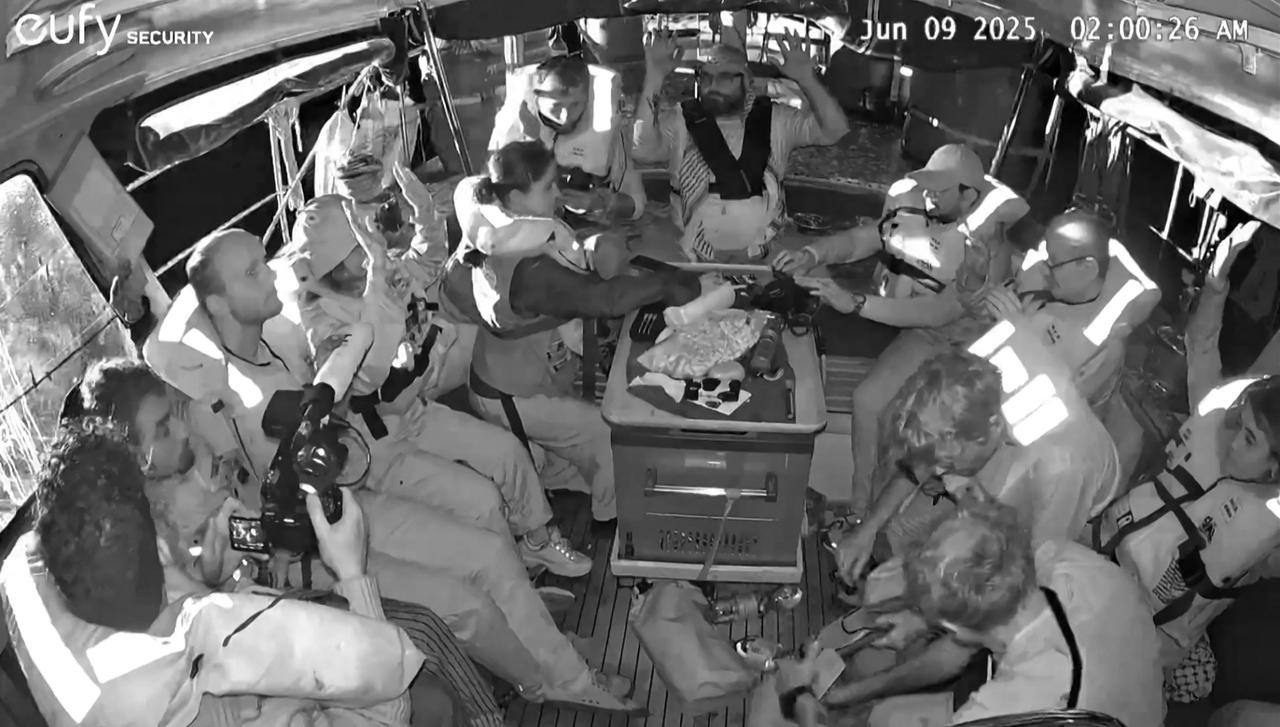 An image grab from footage released by Freedom Flotilla Coalition on June 9, 2025 shows activists on board the Gaza-bound aid boat Madleen, with their hands in the air, as they are being intercepted by the Israeli forces in international waters before reaching the blockaded Palestinian territory. The boat was redirected to Israels shores, preventing the activists onboard, including Swedish campaigner Greta Thunberg and European parliament member Rima Hassan, from reaching the Gaza Strip. (AFP Photo)
