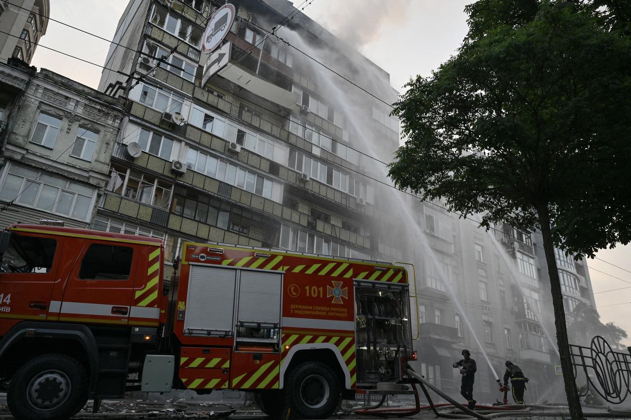 Ukrainian firefighters extinguish a fire in a residential building following a Russian missile and drone attack in Kyiv on July 10, 2025. (AFP Photo)