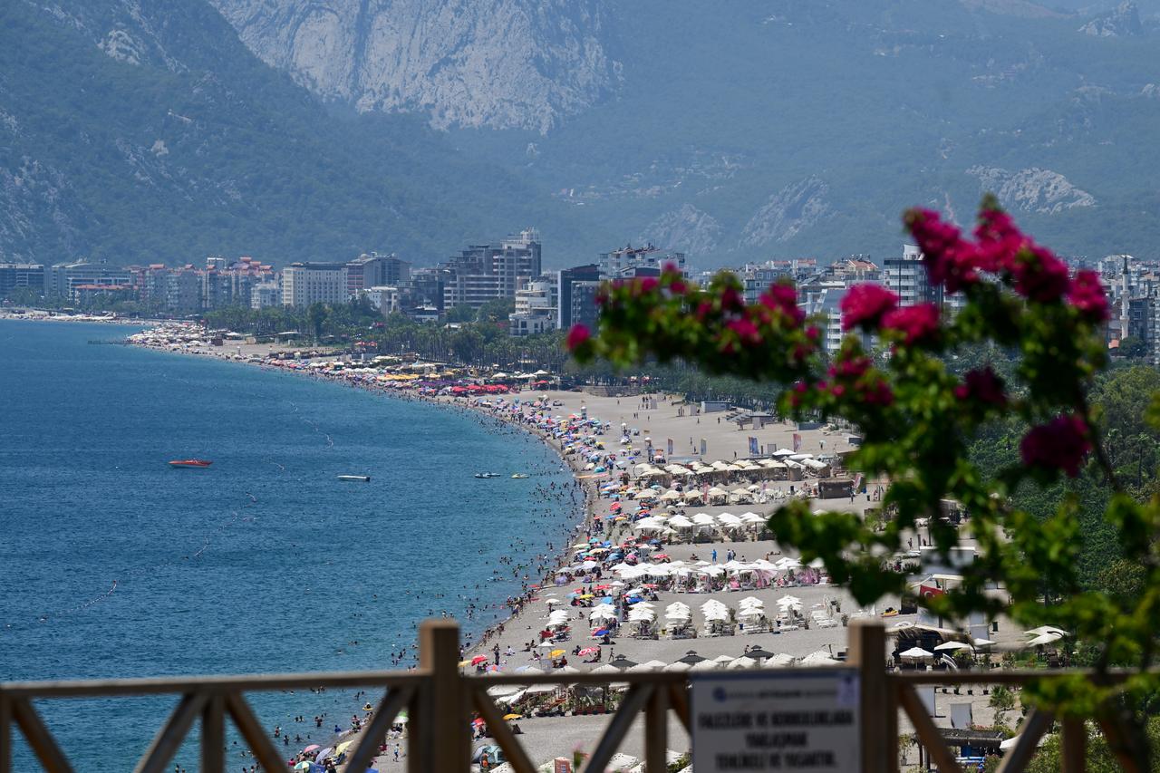 Residents of the city and local and foreign tourists spending time on the Konyaalti beach to cool off due to the ongoing heat on June 28, 2025 in Antalya, Türkiye. (AA Photo)