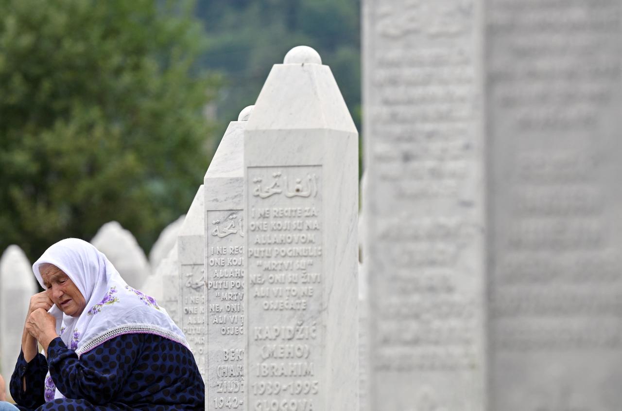A Bosnian Muslim prays as they visit graves of relatives at the memorial cemetery in village of Potocari, near the Eastern-Bosnian town of Srebrenica, on July 10, 2025. (AFP Photo)