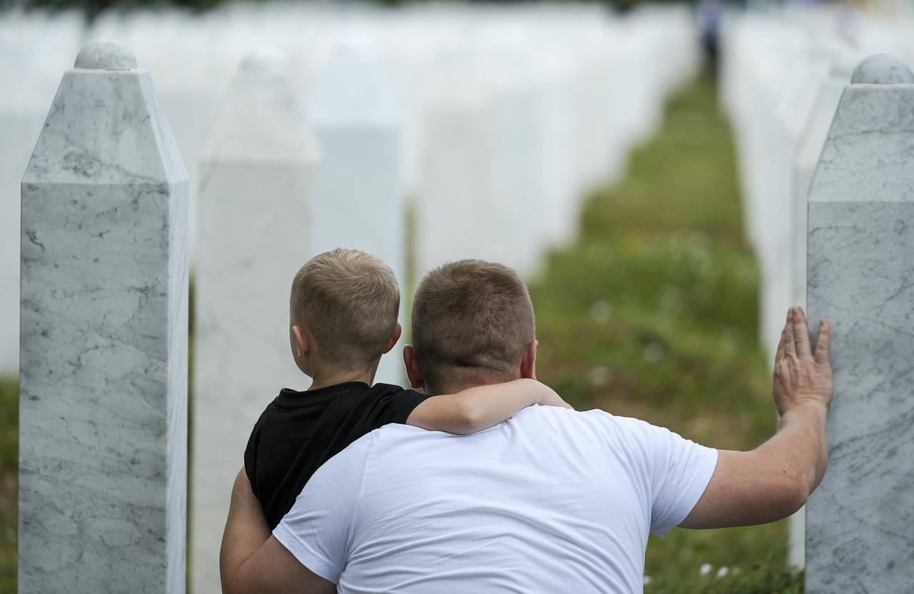 Relatives mourn and pray beside a gravestones at the Srebrenica–Potocari Memorial Cemetery ahead of the annual commemoration ceremony as families continue to visit the graves of loved ones killed in the 1995 Srebrenica genocide in Srebrenica, Bosnia and Herzegovina on July 10, 2025. (AA Photo)