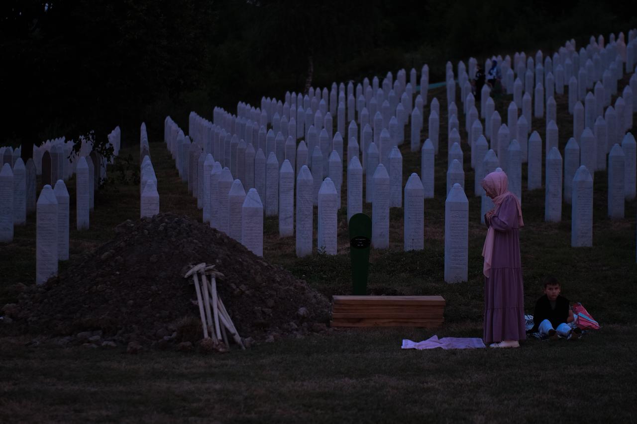 People pray among the gravestones at the Potocari Memorial Cemetery as part of the 30th anniversary commemorations of the 1995 Srebrenica Genocide, in Potocari, Bosnia and Herzegovina, on July 10, 2025. (AA Photo)