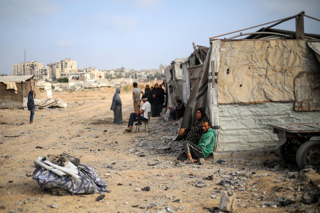 Palestinians sit in front of their makeshift home in the Bureij refugee camp in the central Gaza Strip on July 10, 2025. (AFP Photo)