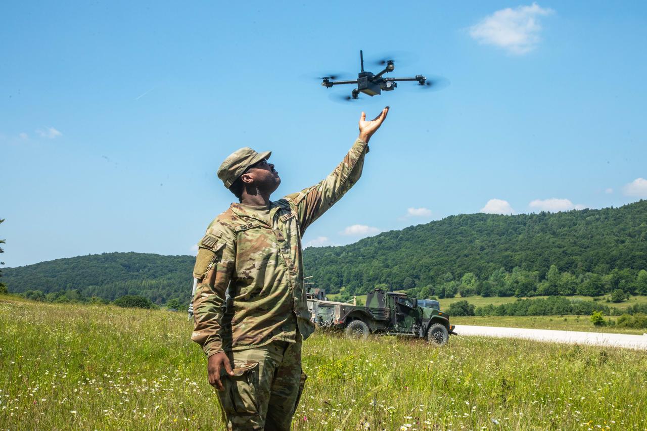 A soldier reaches for an unmanned aerial system during Project Flytrap at Joint Multinational Readiness Center in Hohenfels, Germany, June 19, 2025. (Photo via U.S. Army)