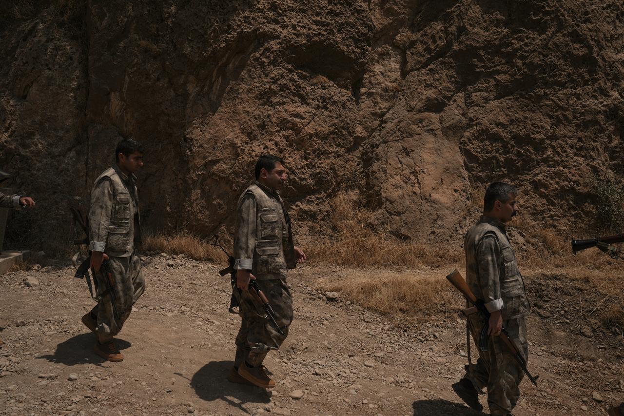 The first group of PKK terrorists lays down and destroys their weapons in Sulaymaniyah, northern Iraq on July 11, 2025. (AA Photo)
