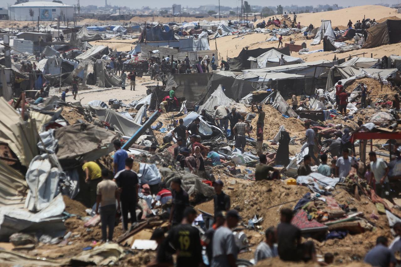 Palestinians inspect the destruction at a makeshift displacement camp following a reported incursion by Israeli tanks in the area in Khan Yunis in the northern Gaza strip on July 11, 2025. (AFP Photo)