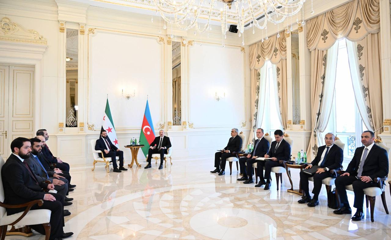 Syrian President Ahmed al-Sharaa (C-L) meets with Azerbaijan's President Ilham Aliyev (C-R) in Azerbaijan capital Baku during an official visit on July 12, 2025. (Azerbaijani Presidency / Handout)