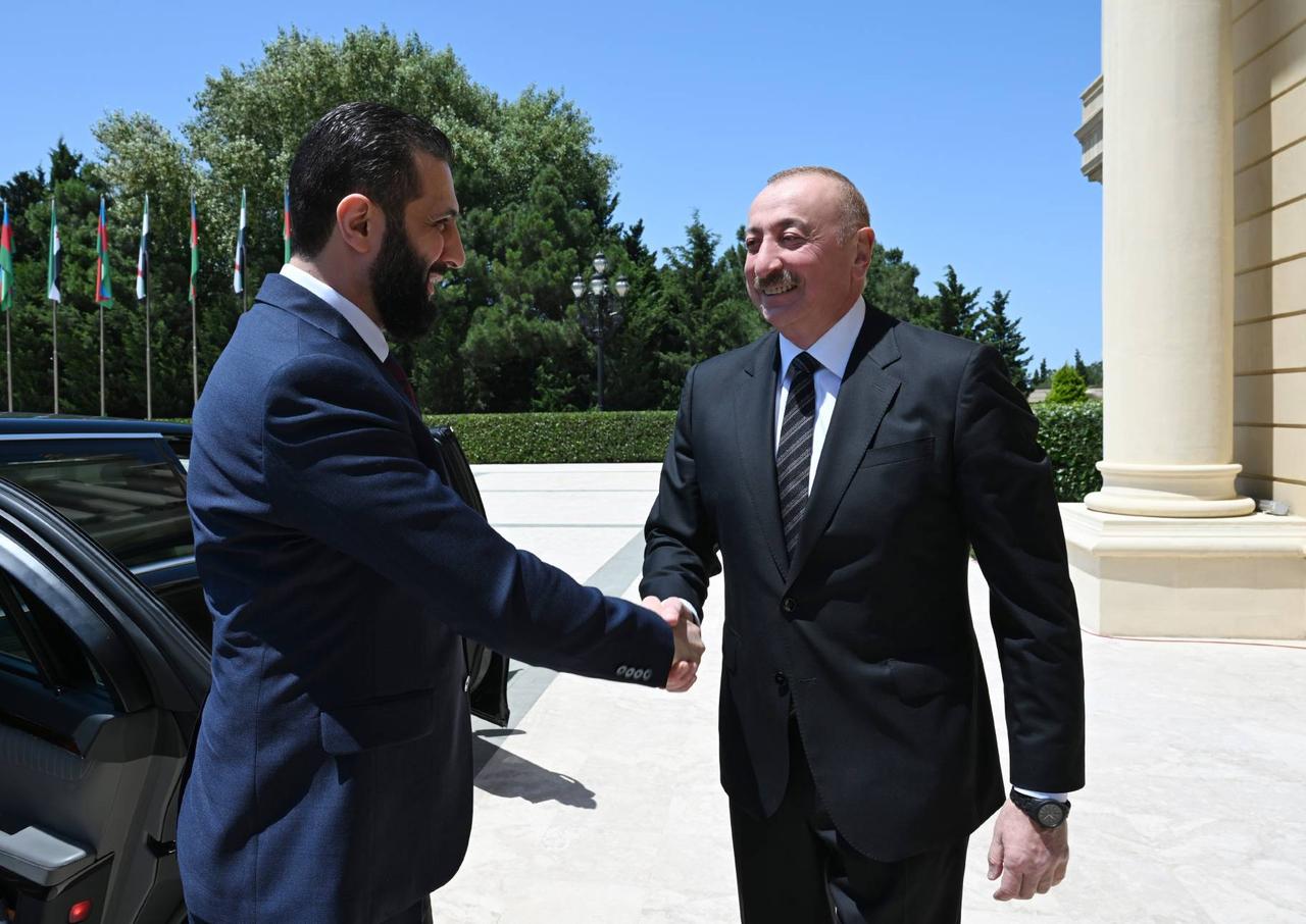 Syrian President Ahmed al-Sharaa (L) meets with Azerbaijan's President Ilham Aliyev (R) in Azerbaijan capital Baku during an official visit on July 12, 2025. (Azerbaijani Presidency / Handout)