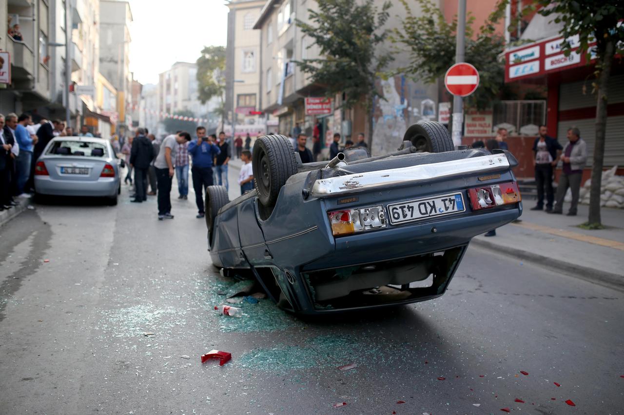 A car is turned down during the unauthorized protesters, taken place in Esenyurt district of Istanbul on October 7, 2014 in Türkiye. (AA Photo)