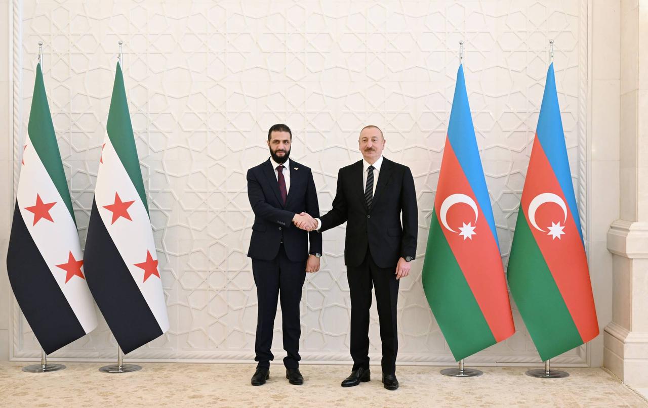 Syrian President Ahmed al-Sharaa (L) meets with Azerbaijan's President Ilham Aliyev (R) in Azerbaijan capital Baku during an official visit on July 12, 2025. (AA Photo)