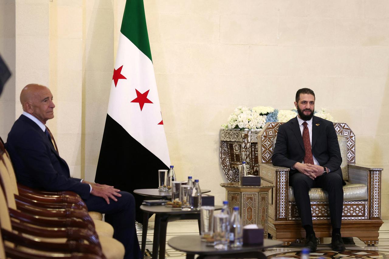 Syria's interim President Ahmad al-Sharaa (R) receives US Special Envoy to Syria Thomas Barrack, at the presidential palace in Damascus on July 9, 2025. (AFP Photo)