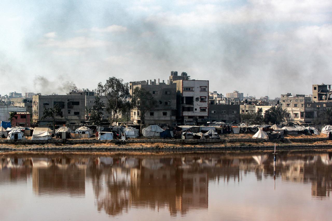 Encampments sheltering Palestinians displaced by conflict are pitched near Sheikh Radwan wastewater collection pond in Gaza City on July 14, 2025. (AFP Photo)