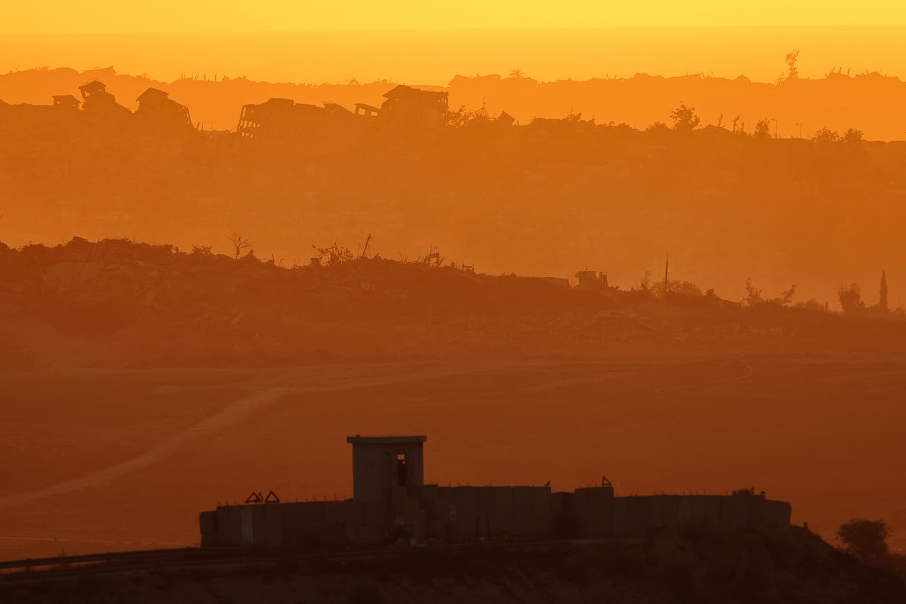The sun setting over destroyed buildings in the besieged Palestinian territory on July 8, 2025. (AFP Photo)