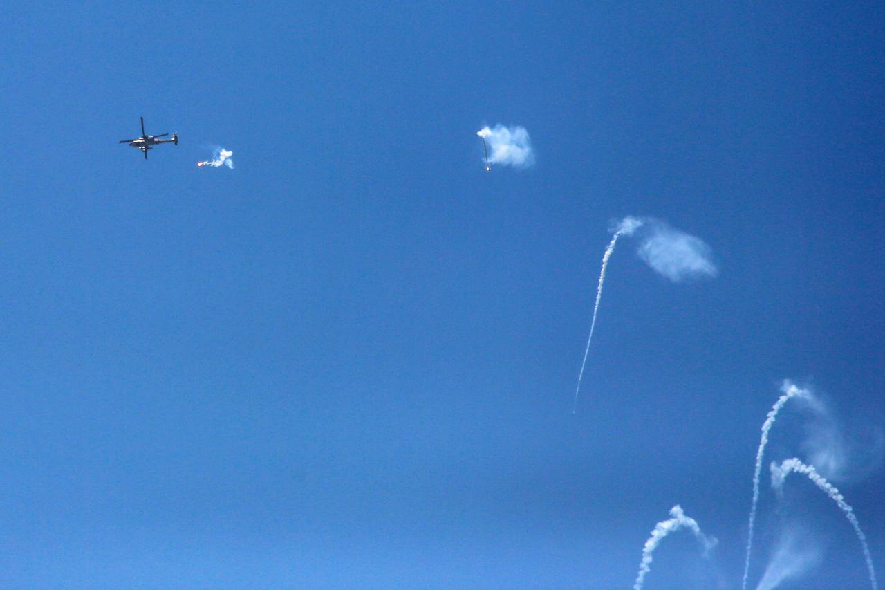 Israeli army helicopter firing flares as it flies over Beit Lahia, Gaza Strip  on July 13, 2025. (AFP Photo)