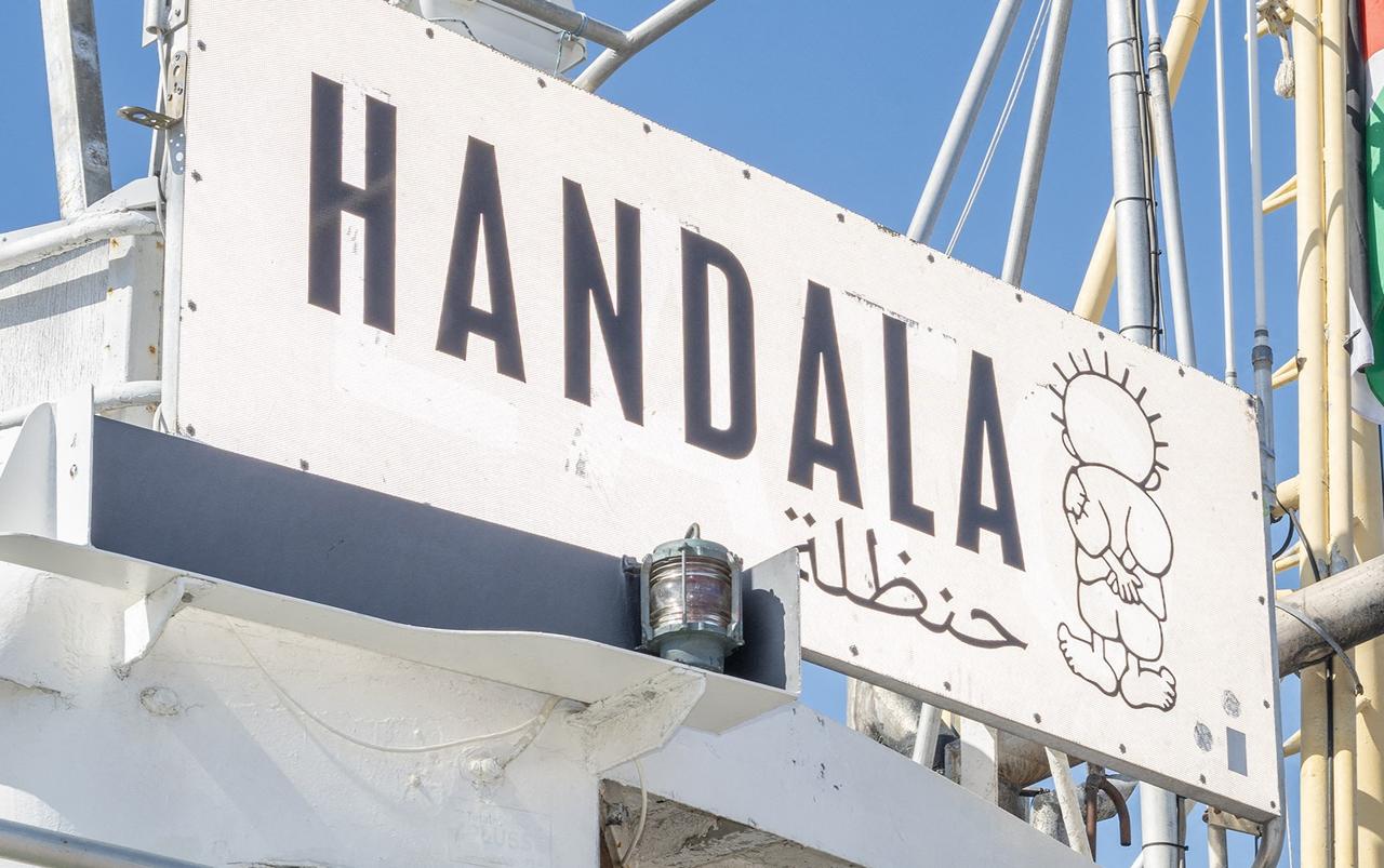 The figure of the Handala painted on the boat that is heading to Gaza at a port in Syracuse, Sicily, southern Italy,July 13, 2025.(Photo by AFP )