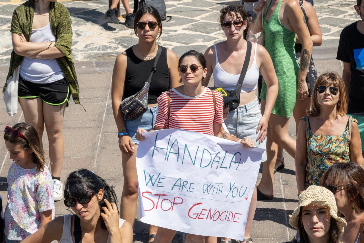 A demonstrator holds a placard reading "Handala we are with you" during a gathering for the Freedom Flotilla ship "Handala" ahead of the boat's departure for Gaza at a port in Syracuse, Sicily, southern Italy, July 13, 2025.( Photo by AFP )