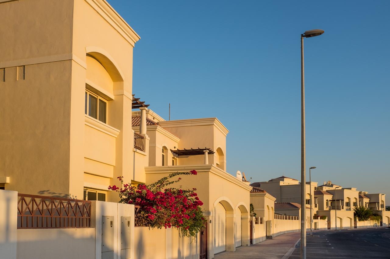 Residential villas line a quiet street in Al Barsha, Dubai, UAE. (Adobe Stock Photo)