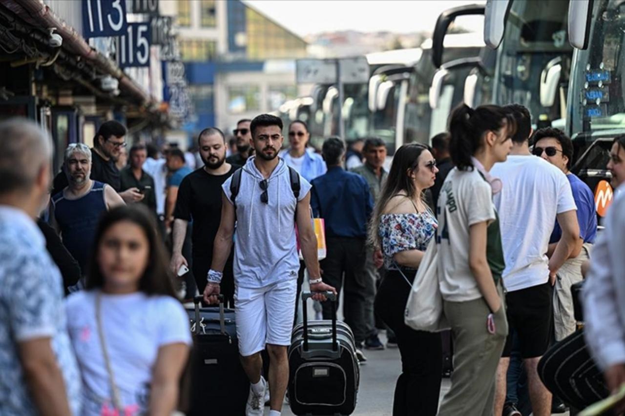 Travelers walk with luggage at a provincial bus terminal in Istanbul, Türkiye. (AA Photo)