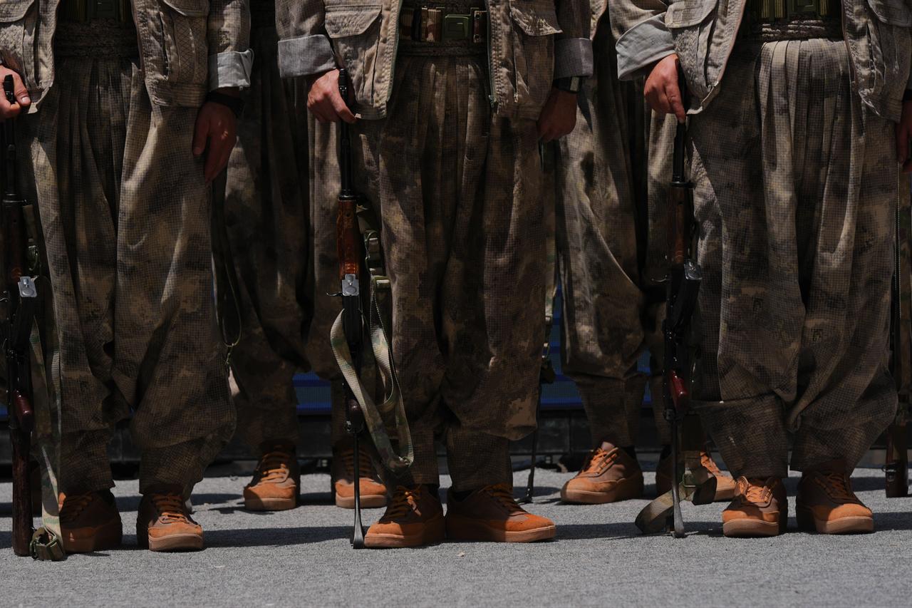 The first group of PKK terrorists lays down and destroys their weapons in Sulaymaniyah, northern Iraq on July 11, 2025. (AFP Photo)