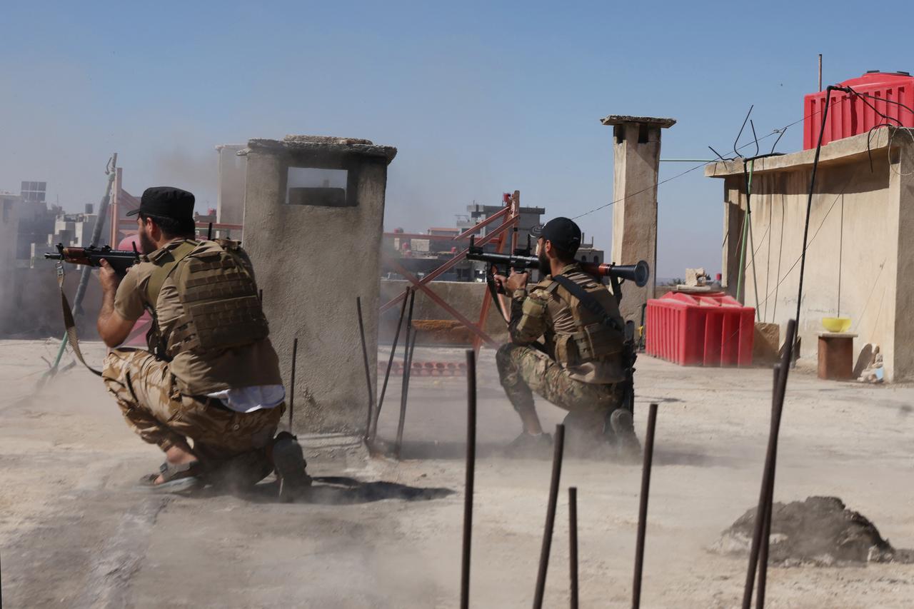 Syrian security forces take aim from a rooftop position amid ongoing clashes in the southern city of Sweida on July 16, 2025. (AFP Photo)