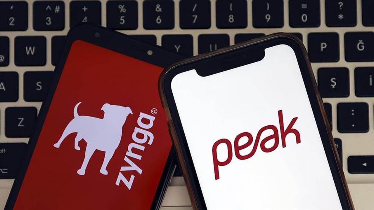 Logos of Zynga and Peak Games displayed on smartphones. (AA Photo)