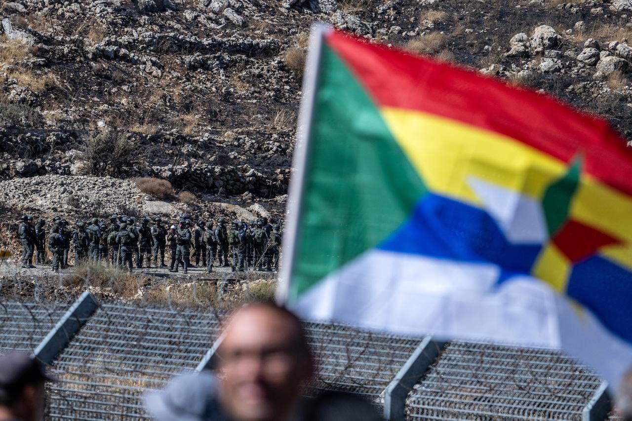 Members of the Druze community gather near the barbed wire fence along the Golan Heights, to stage a demonstration in solidarity with Druze residents in southern Syria's Suwayda, July 16, 2025.( Photo by AA)