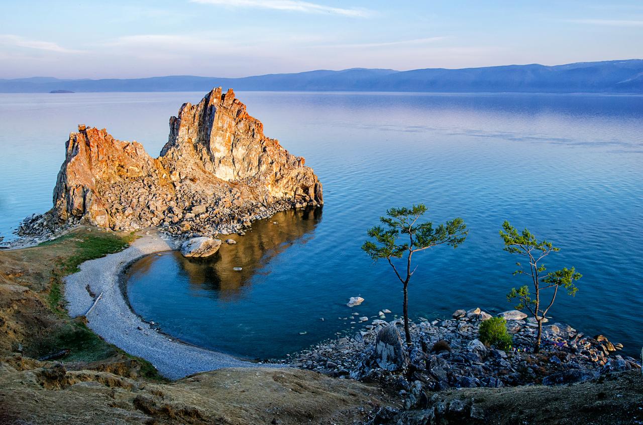 Summer sunset over Shamanka (Shaman Rock) on Olkhon Island in Lake Baikal, Russia, accessed July 17, 2025. (Adobe Stock Photo)