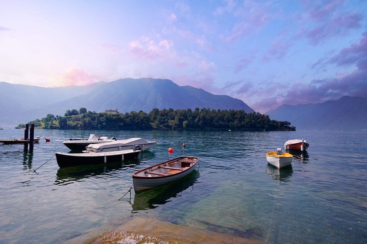 Beautiful scene of boats on blue Lake Como, surrounded by green hills, Italy, accessed July 17, 2025. (Adobe Stock Photo)