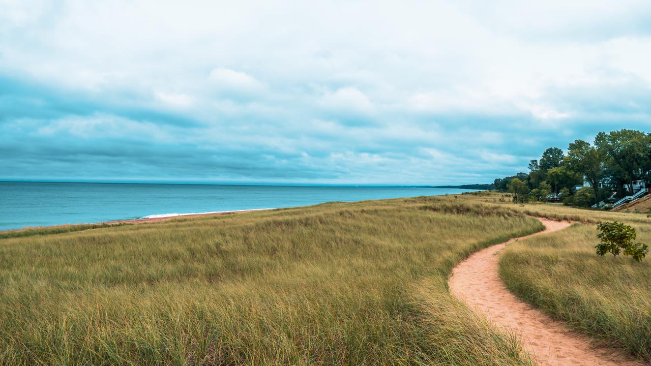 Beautiful landscape of Lake Michigan dunes and beach in New Buffalo, Michigan, accessed July 17, 2025. (Adobe Stock Photo)