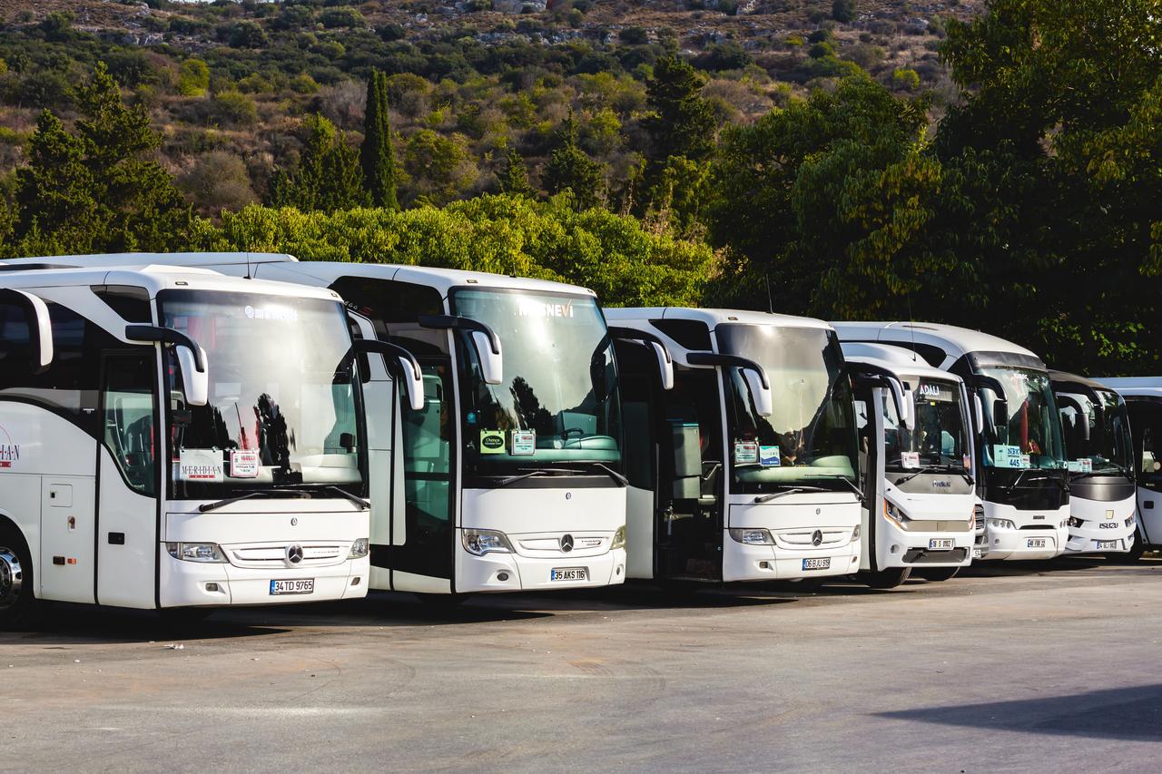 Lineup of tour buses at a parking area in Ephesus in Selcuk, Izmir, Türkiye on Oct 25, 2023. (Adobe Stock Photo)