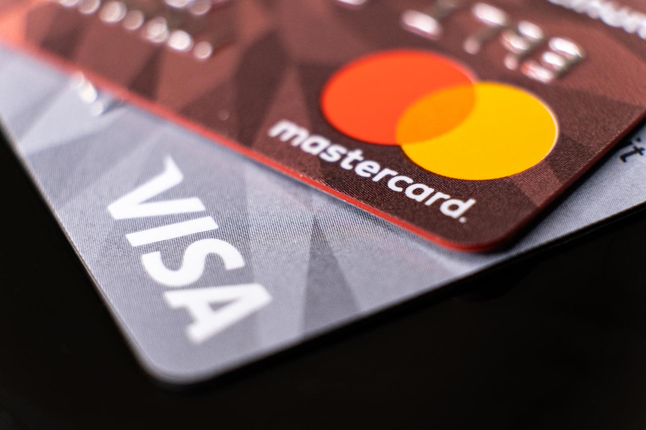 Mastercard and Visa credit cards close up in Istanbul, Türkiye on February, 2022. (Adobe Stock Photo)