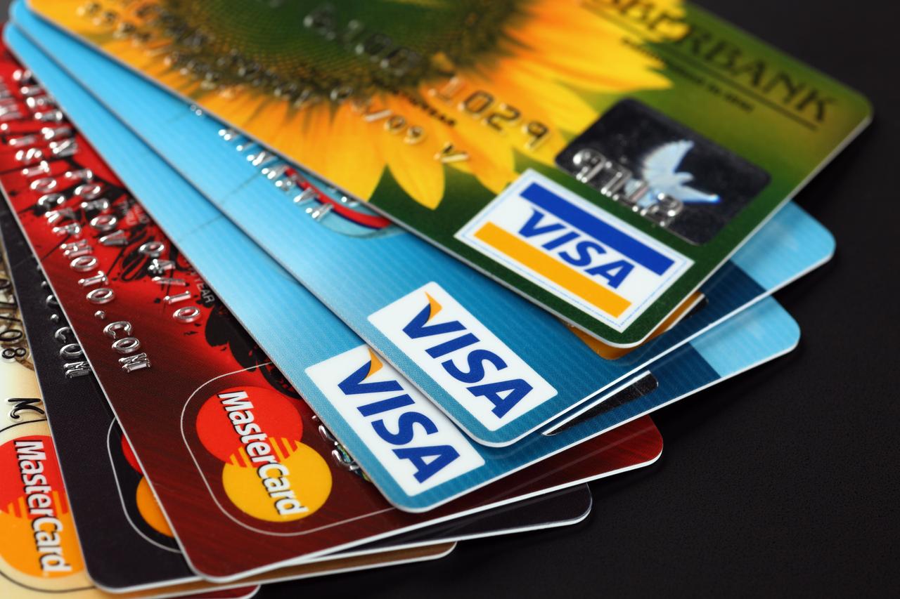 Heap of credit cards with Visa and Mastercard logos in Tambov, Russia on Sept. 11, 2012. (Adobe Stock Photo)