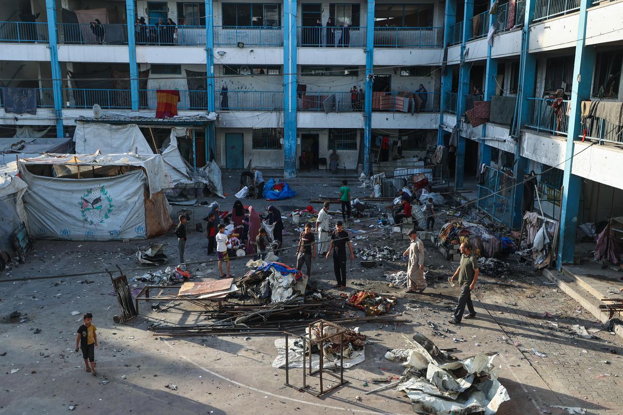 Palestinians salvage items from the debris of a tent which was hit in Israeli strikes at the Bureij refugee camp in the central Gaza Strip on July 17, 2025. (AFP Photo)
